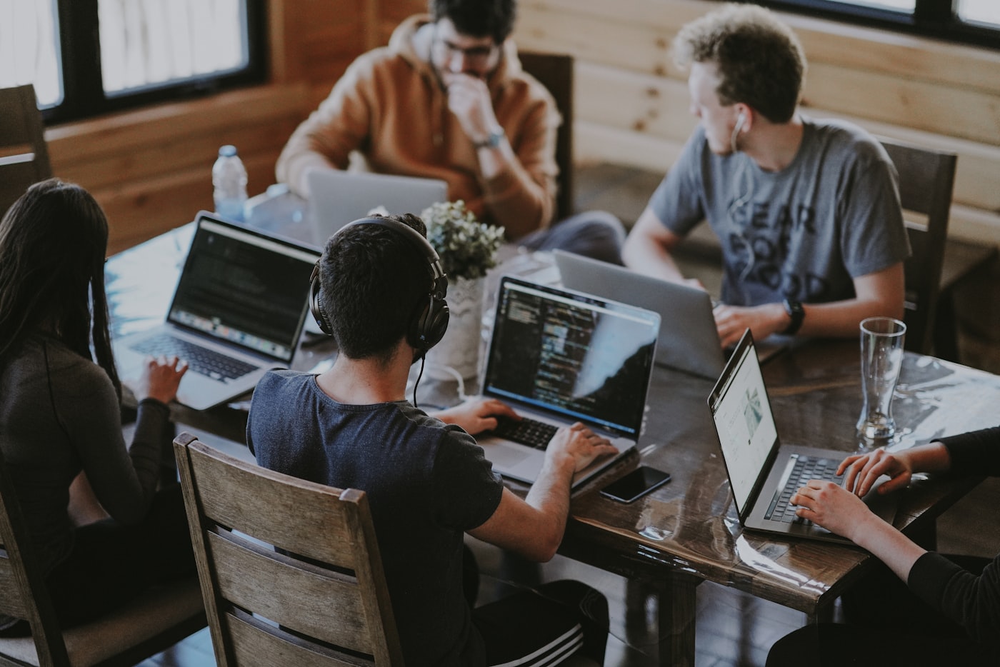 Innovators collaborating around a laptop